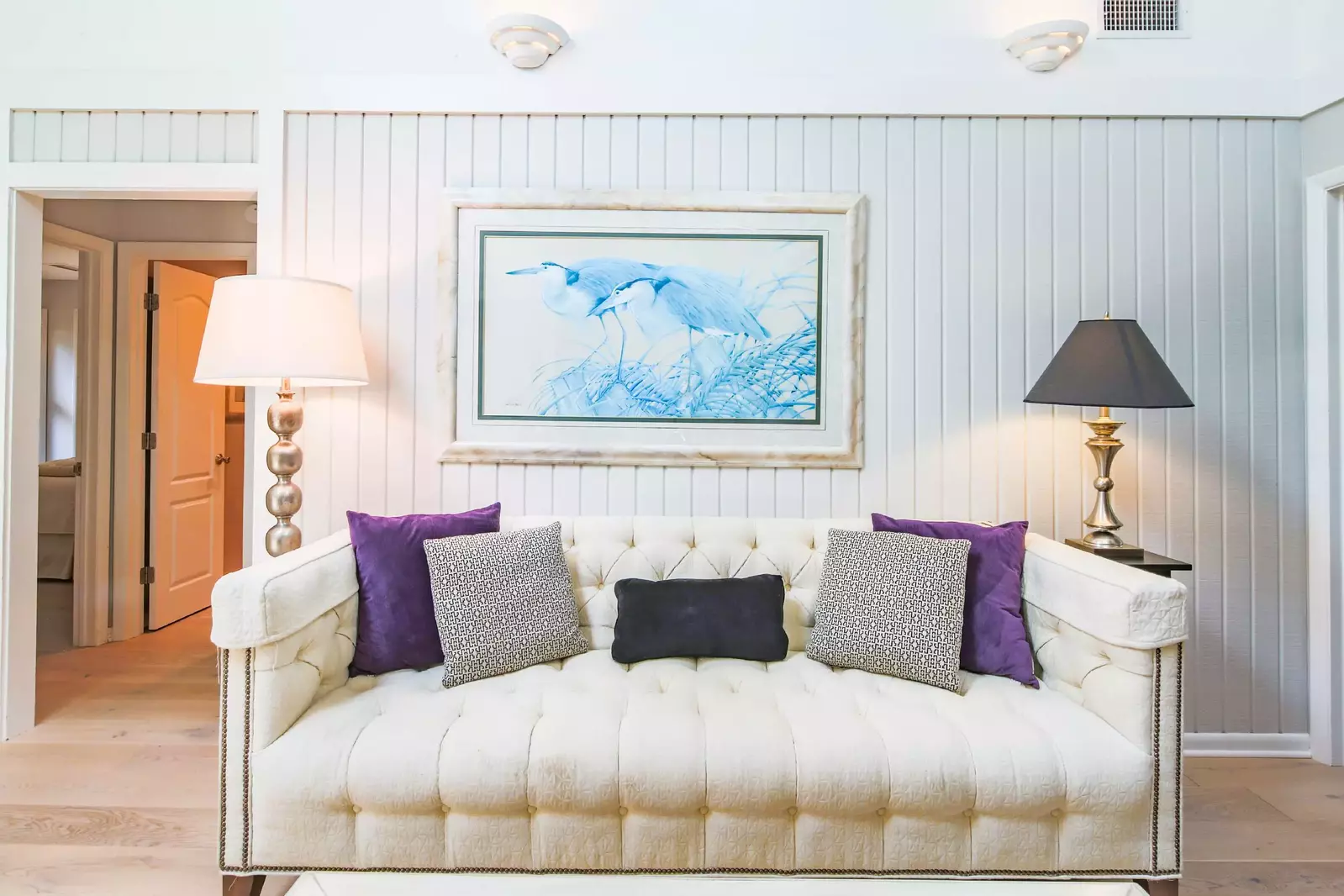 There is also a sofa, shiplap walls and vaulted ceilings in the living room.