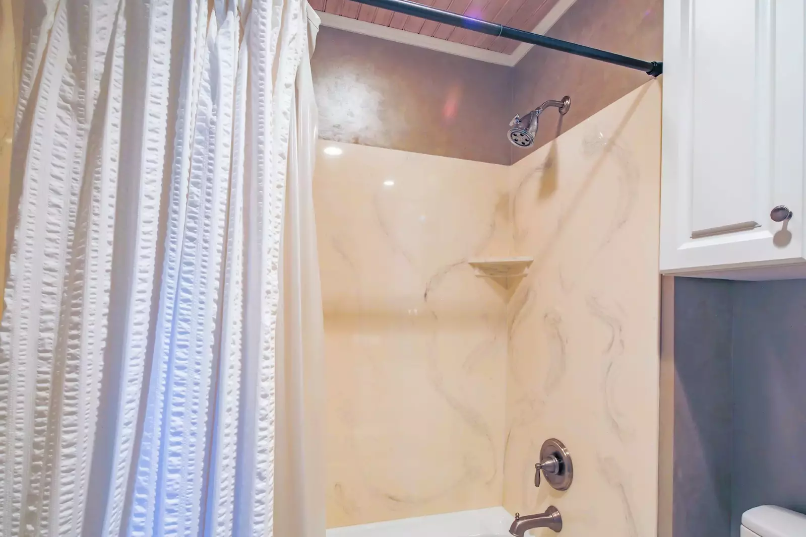 The en suite bathroom also has a shower/tub combo.