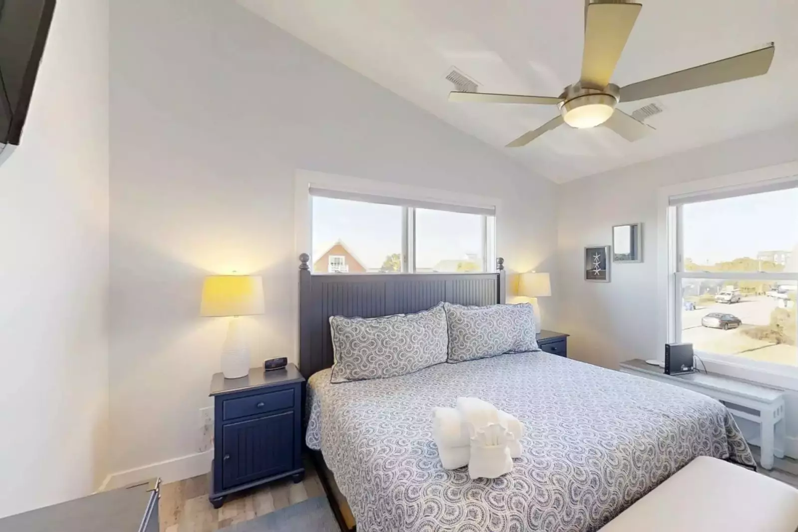 The master suite features a king bed and night stands with reading lamps.