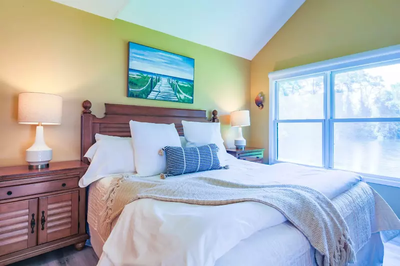 The primary suite features lagoon views and lovely natural light.