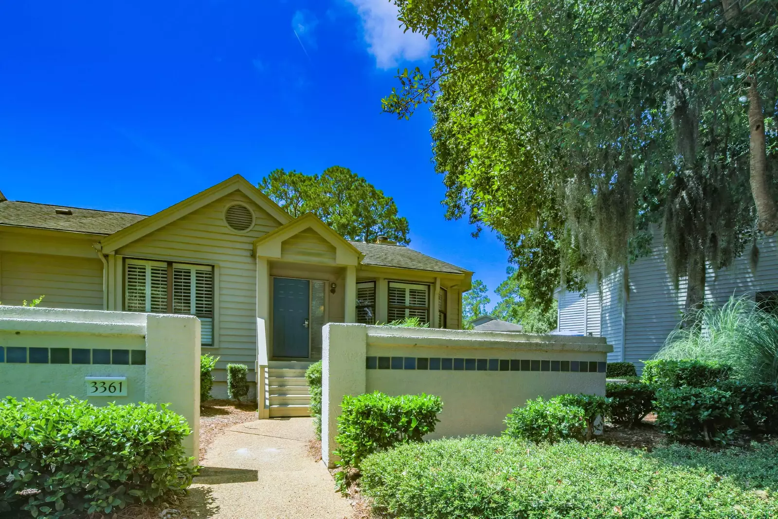 Follow this sidewalk to access the front door of this single story attached villa.