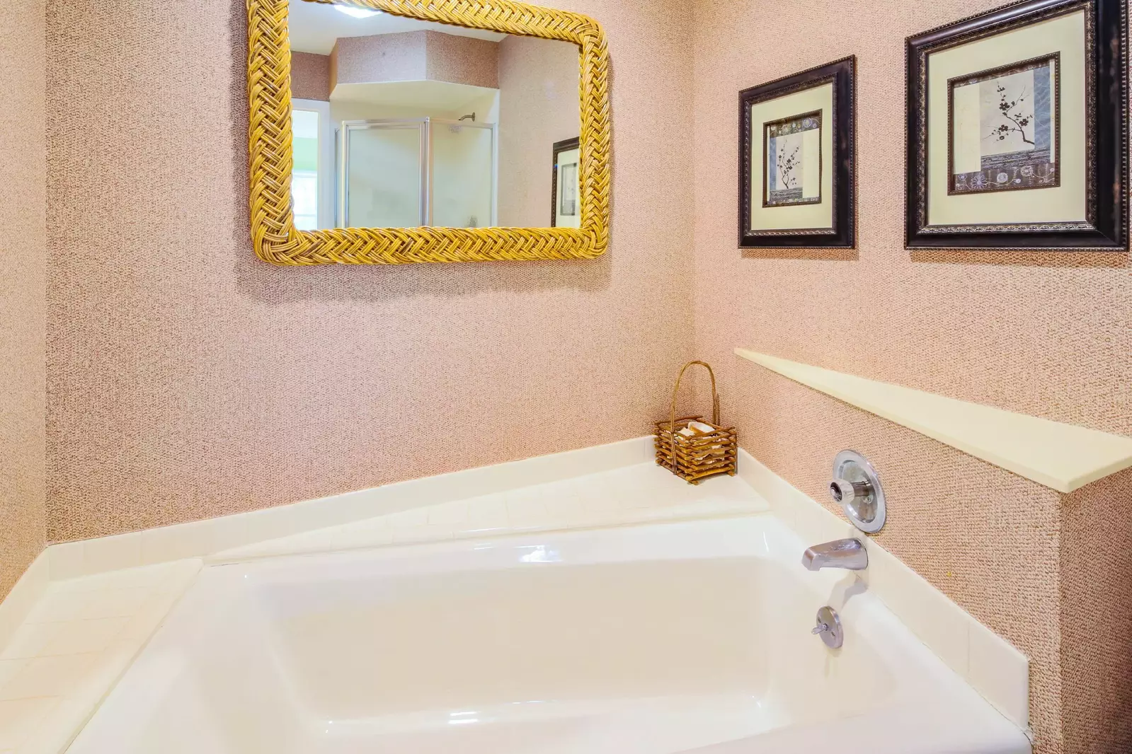 The en suite bathroom has a walk-in shower and a separate bath tub.