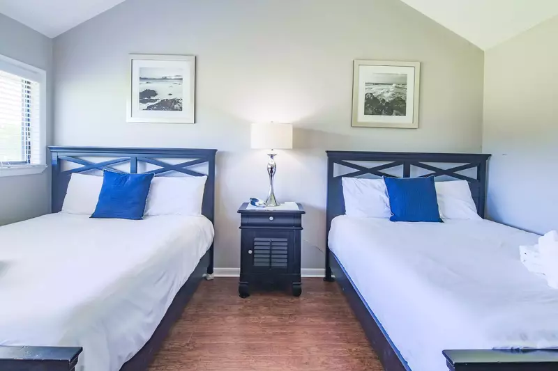 The master suite also has vaulted ceilings and a night stand with a reading lamp.