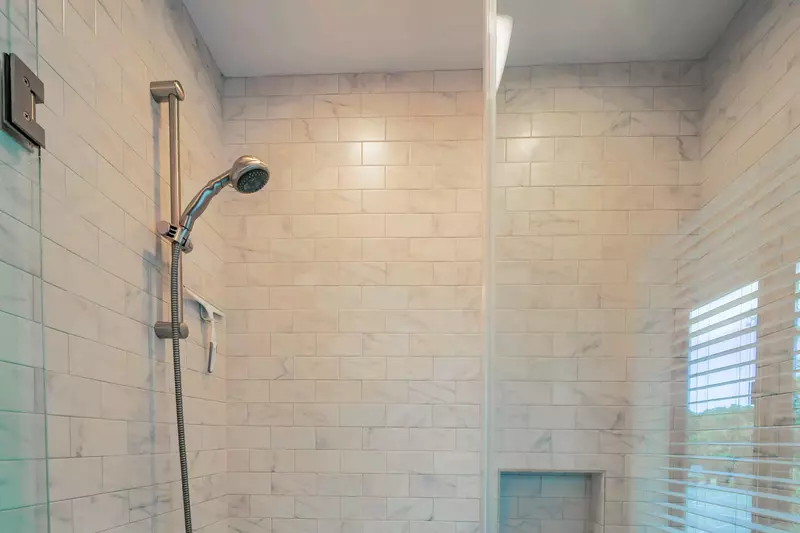 The en suite bathroom also has a tiled, shower/tub combo.