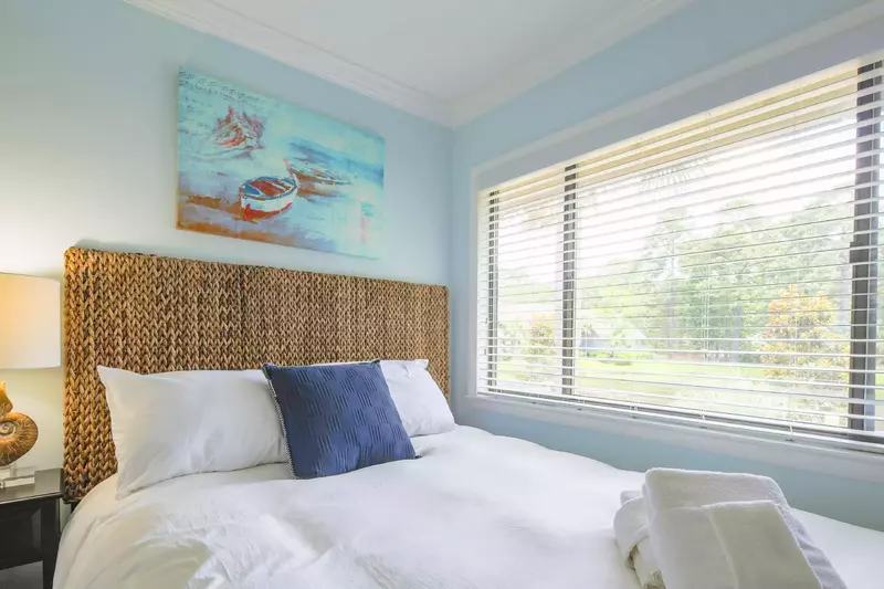 The guest bedroom receives terrific natural light through the large window.