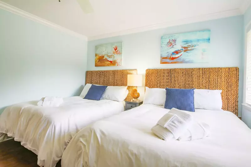 There is also a night stand and reading lamp that separates the two beds.