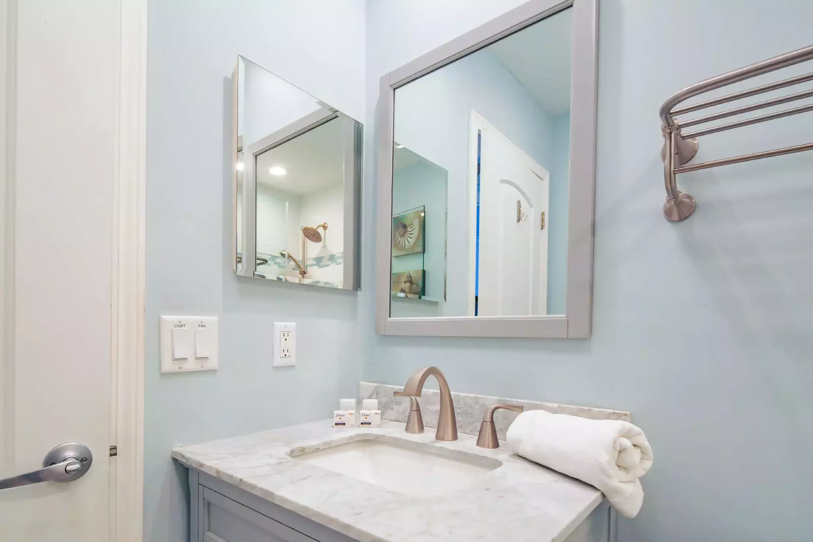 The hallway bathroom features a vanity, mirror and medicine cabinet.