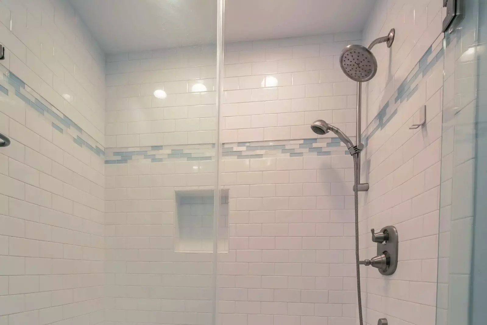 The hallway bathroom also features a tiled, walk-in shower.