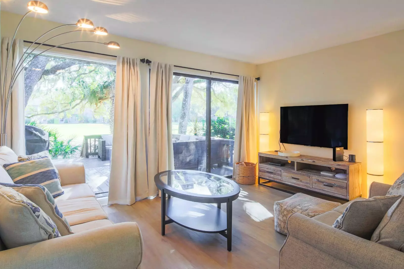 The villa features a comfortable living room with a spacious seating area and golf course views.