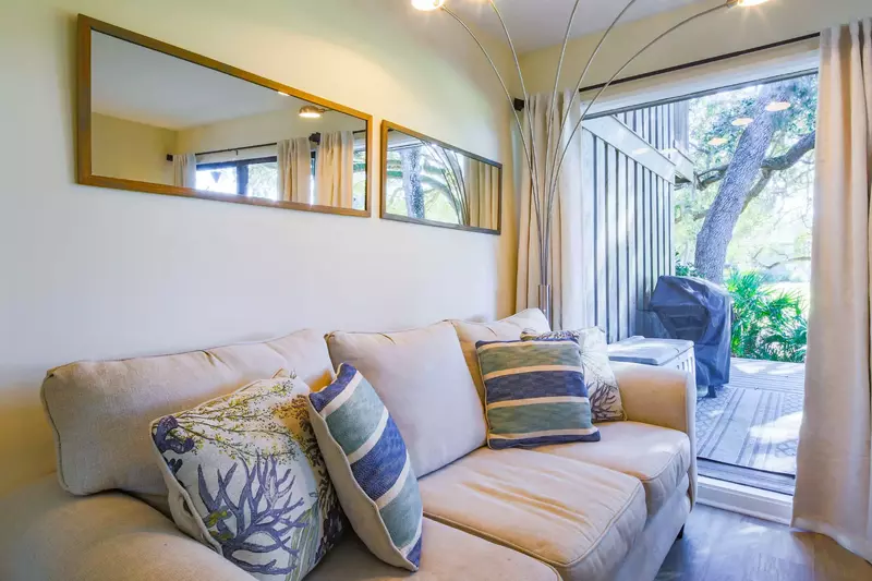 The living room looks out onto the back deck and the landscaping along the Robert Trent Jones golf course.