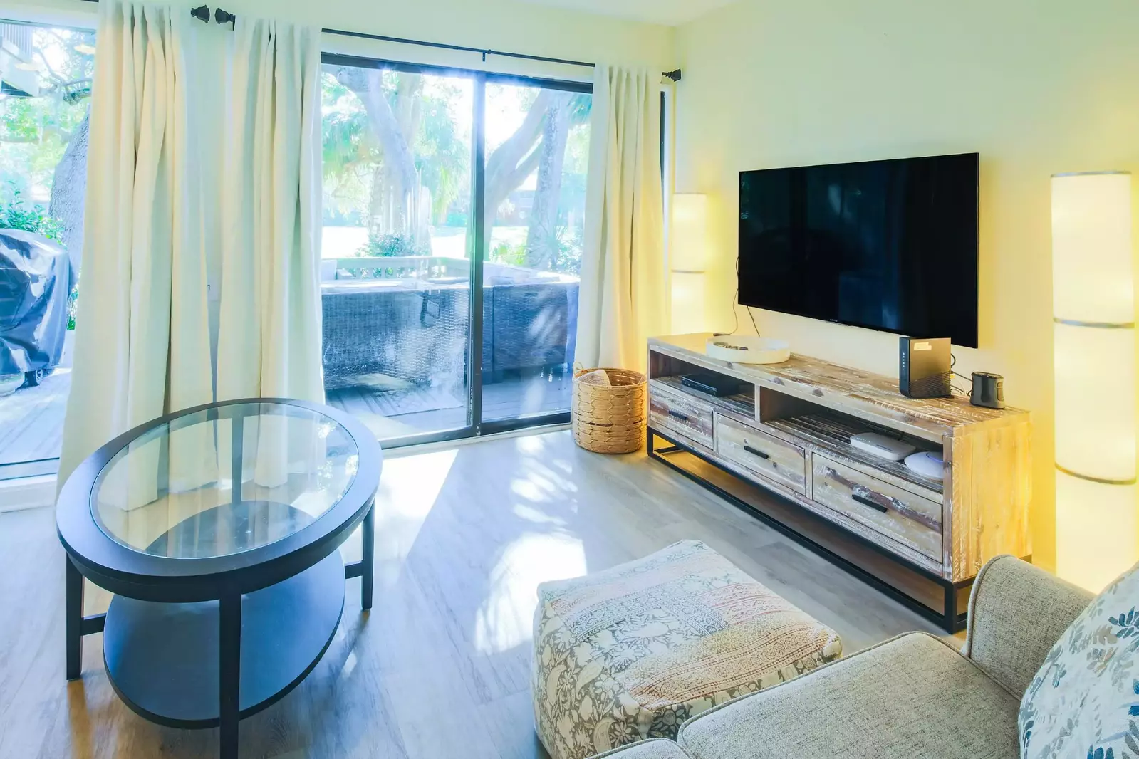 The living room also features a mounted large screen TV.