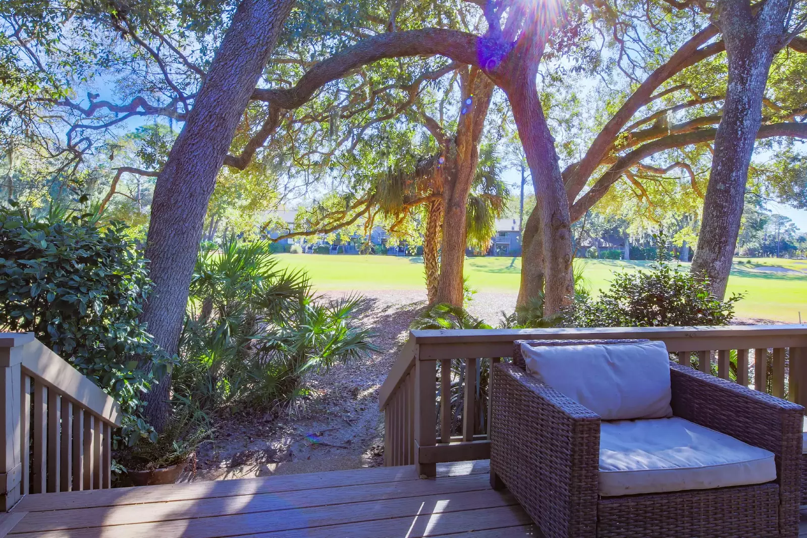 The steps on the back deck lead to the landscaped area alongside the Robert Trent Jones golf course.