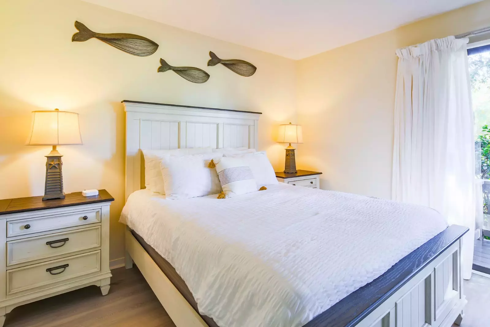 The lower level suite features a queen bed and two night stands with reading lamps.