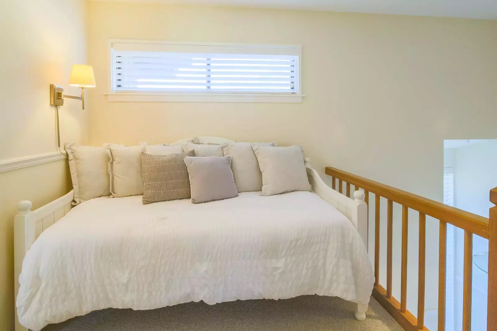 There is a comfortable twin daybed at the top fo the stairs with a wall sconce.
