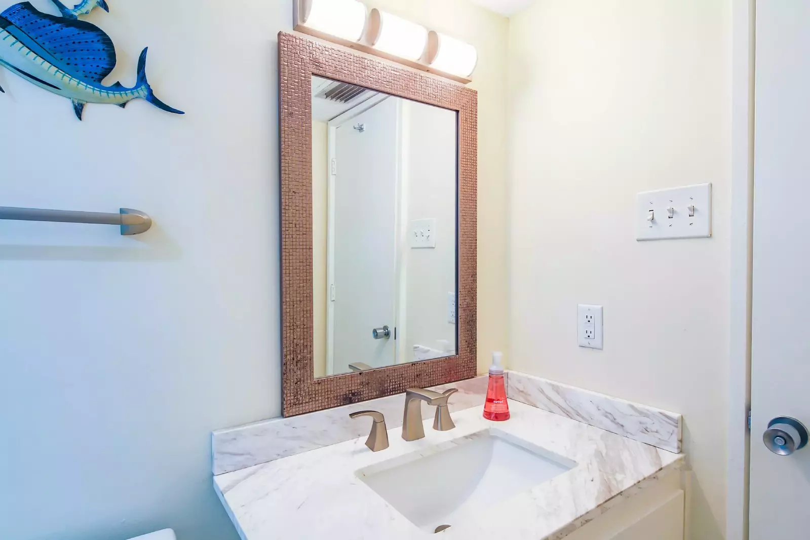 Tne en suite bathroom has a spacious vanity.