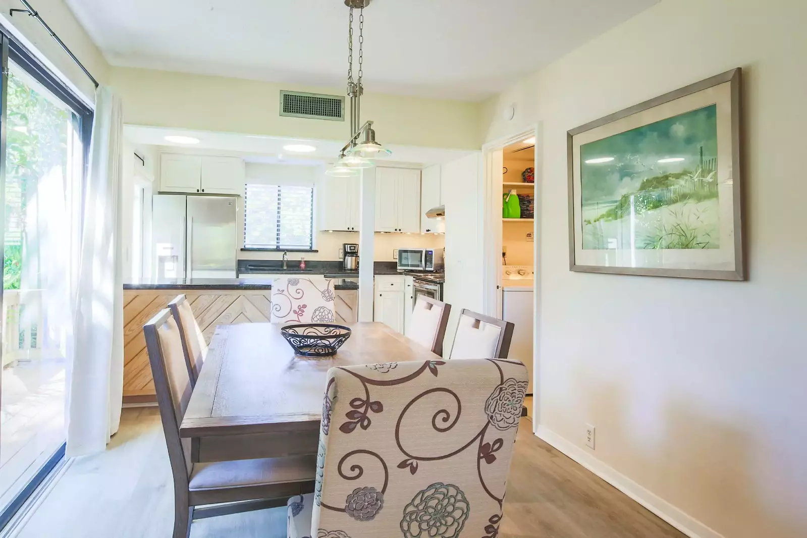 The laundry room is located near the living room and dining area.