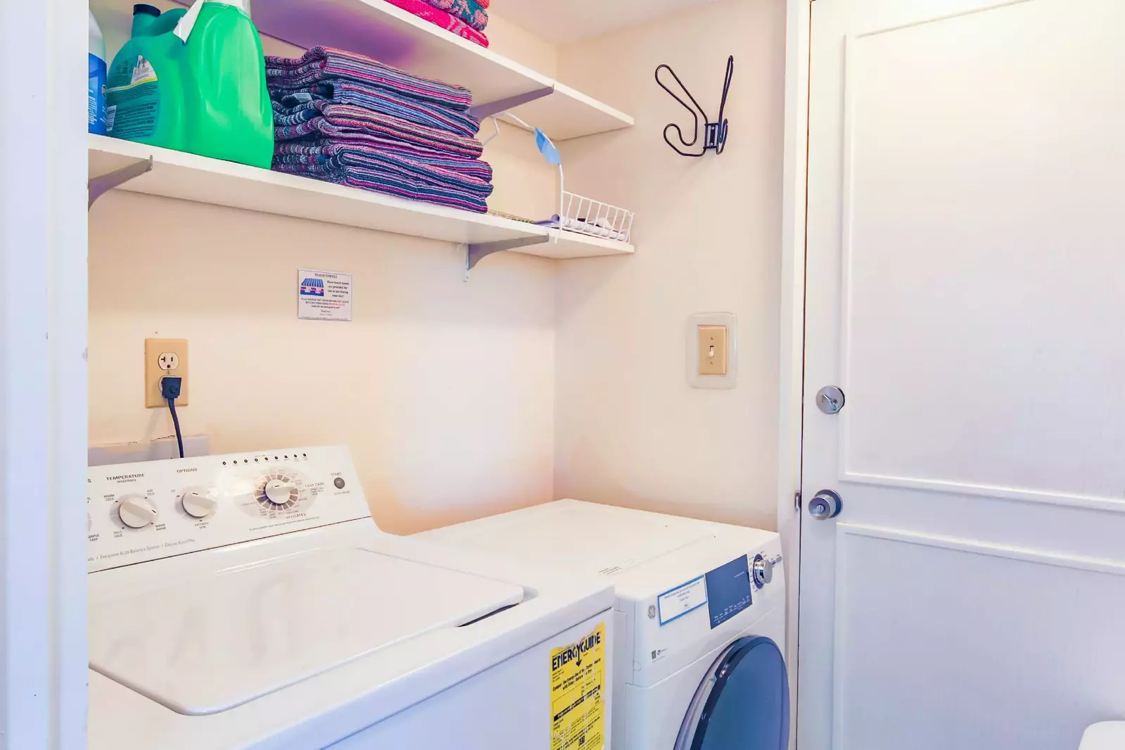 The laundry room has a washing machine, dryer and beach towels for guest use.