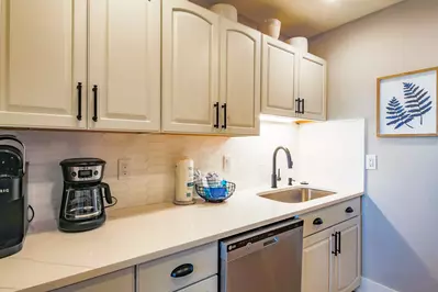 There is plenty of room within the well-stocked kitchen to prepare your family's meals.