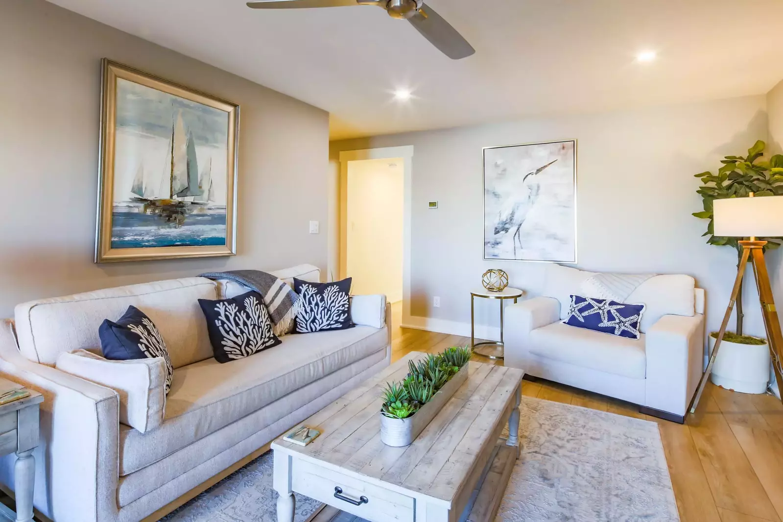 The living room features a comfortable sofa and arm chair.