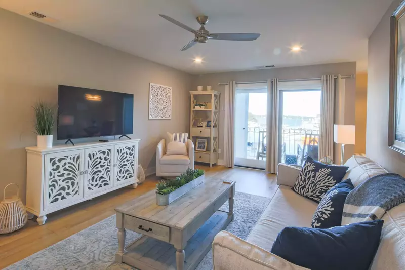 The living room also features a large screen TV, harbour views and access to the balcony.