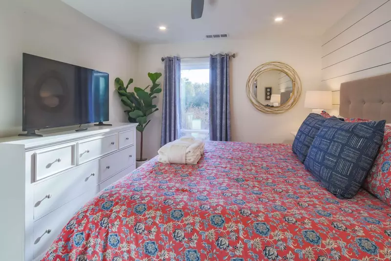The master suite also features a dresser and large screen TV.