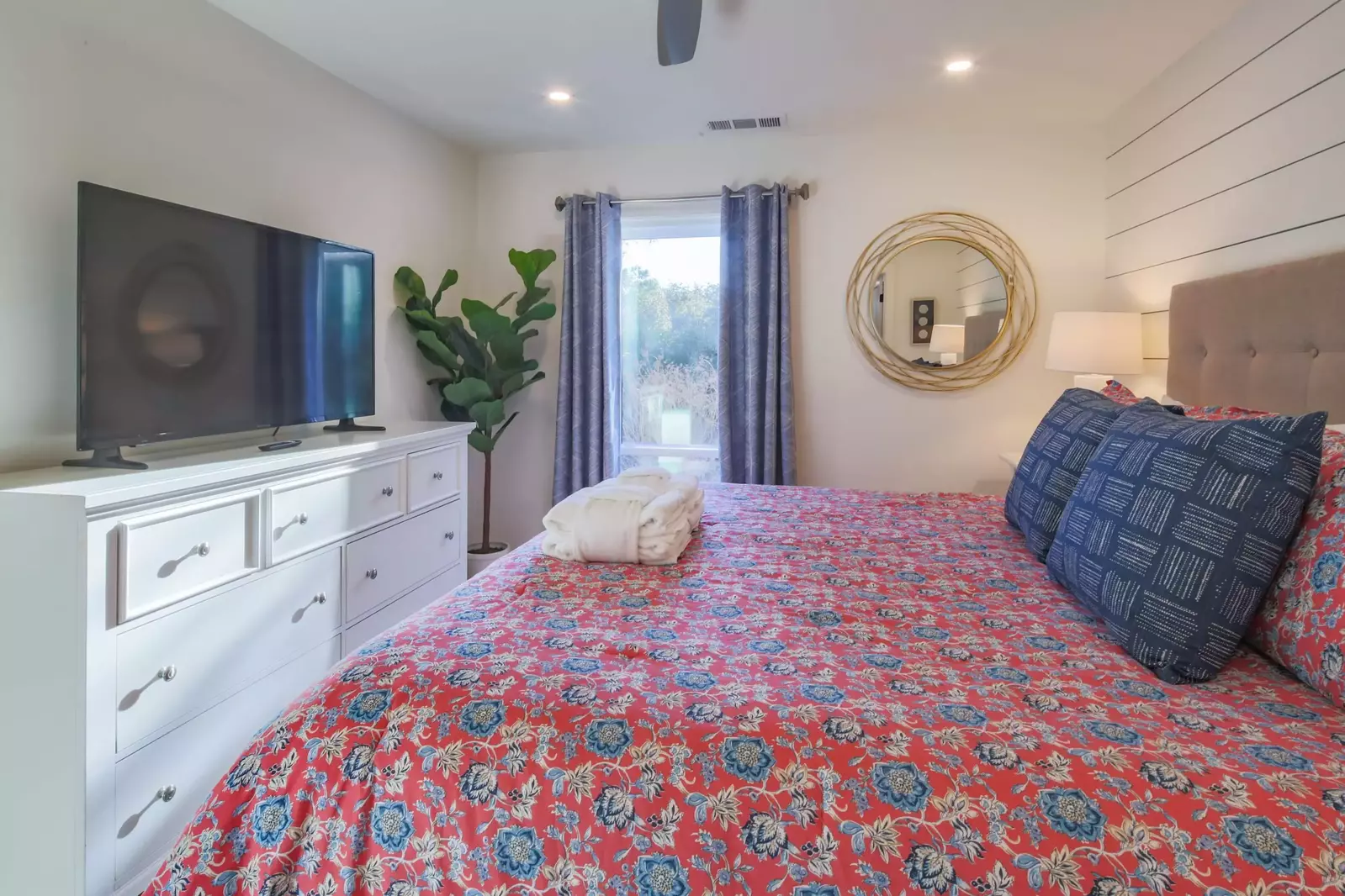 The master suite also features a dresser and large screen TV.