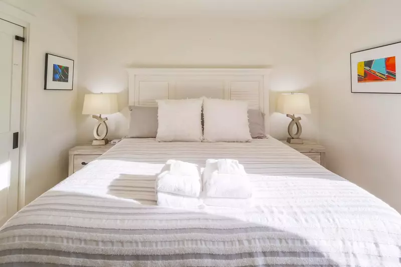 The guest bedroom features a king bed and lovely natural light.