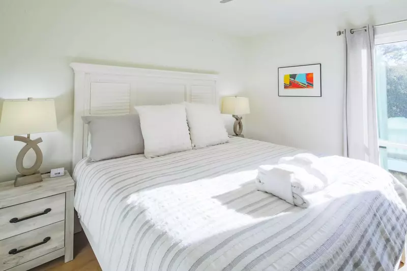 The guest bedroom has two night stands with reading lamps.
