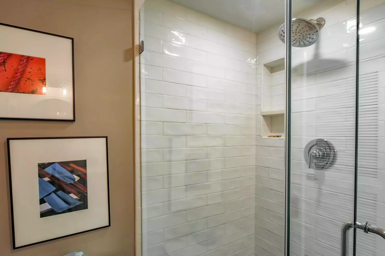 The hallway bathroom also has a tiled, walk-in shower.