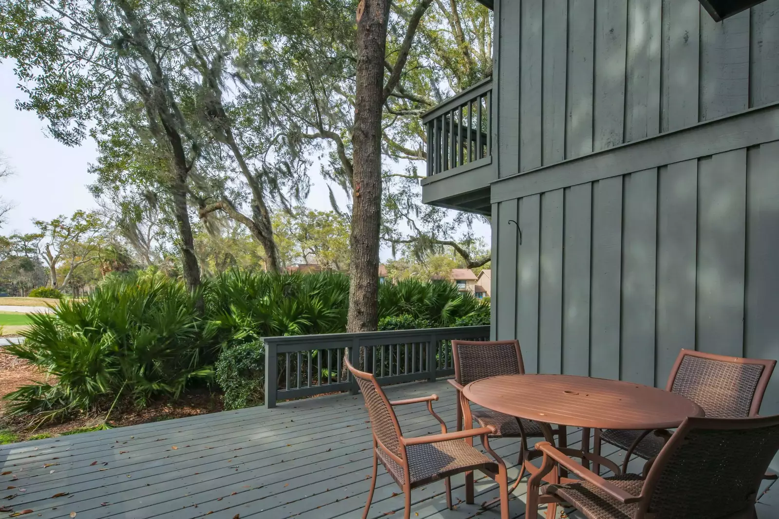 The spacious back deck features an outdoor dining table and chairs.