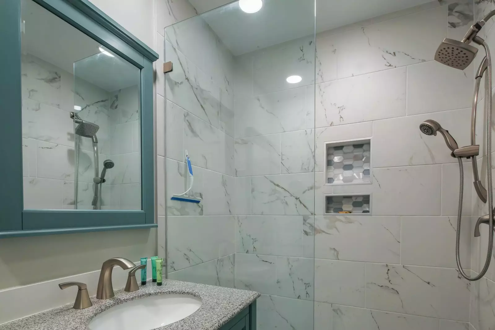 The beautifully tiled walk-in shower has two shower heads.