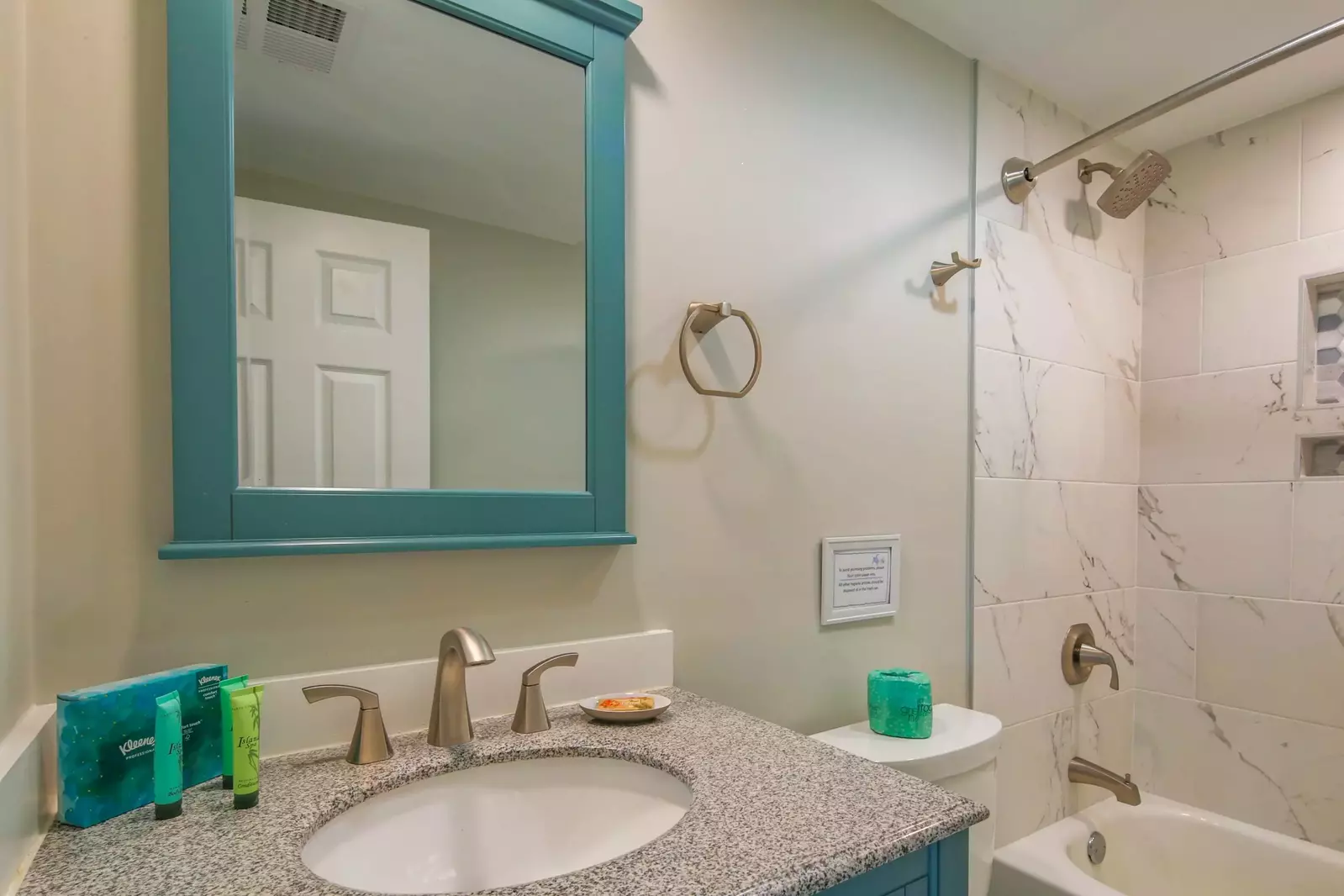 The en suite bathroom features a vanity and shower/tub combo.