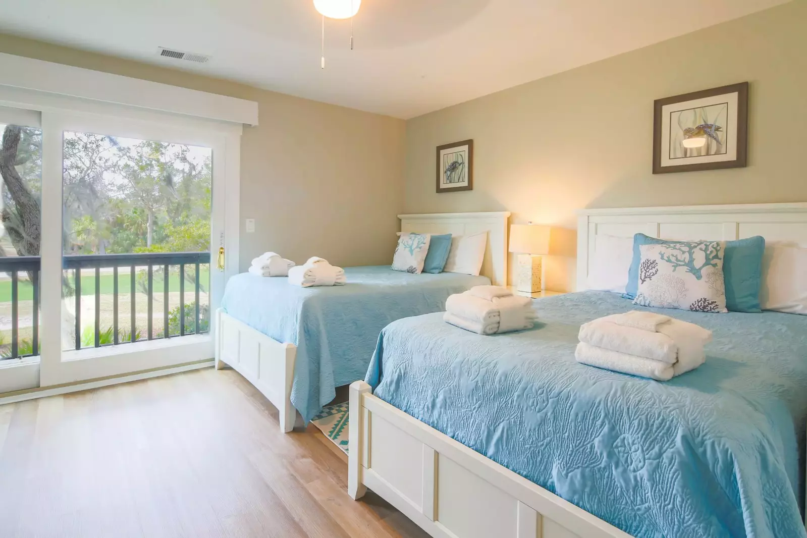 The full suite features two full beds, a night stand with reading lamp and golf course views.