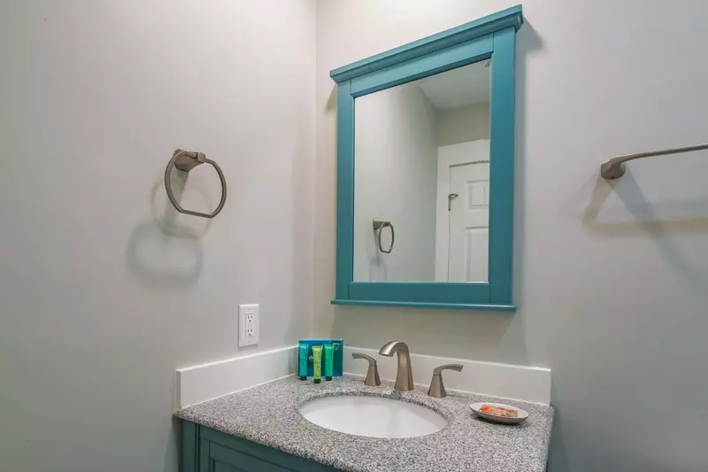 The en suite bathroom features a spacious vanity.
