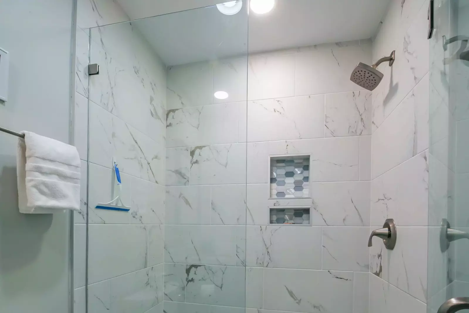 The en suite bathroom also features this tiled, walk-in shower.