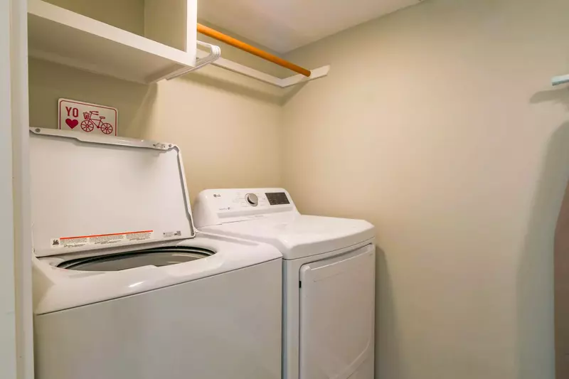 There is a full sized washing machine and dryer near the kitchen.