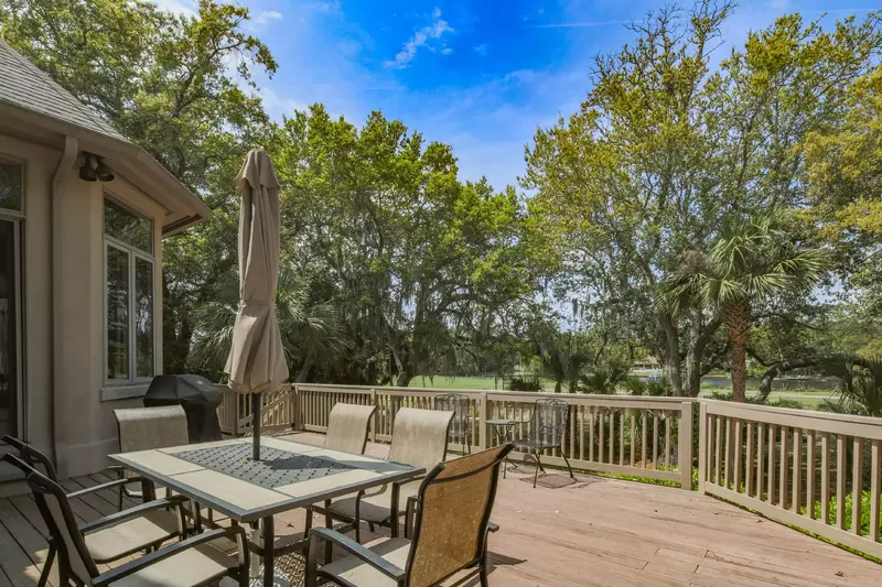 The spacious back deck features golf course views, an outdoor dining table that seats 6 and a gas grill.