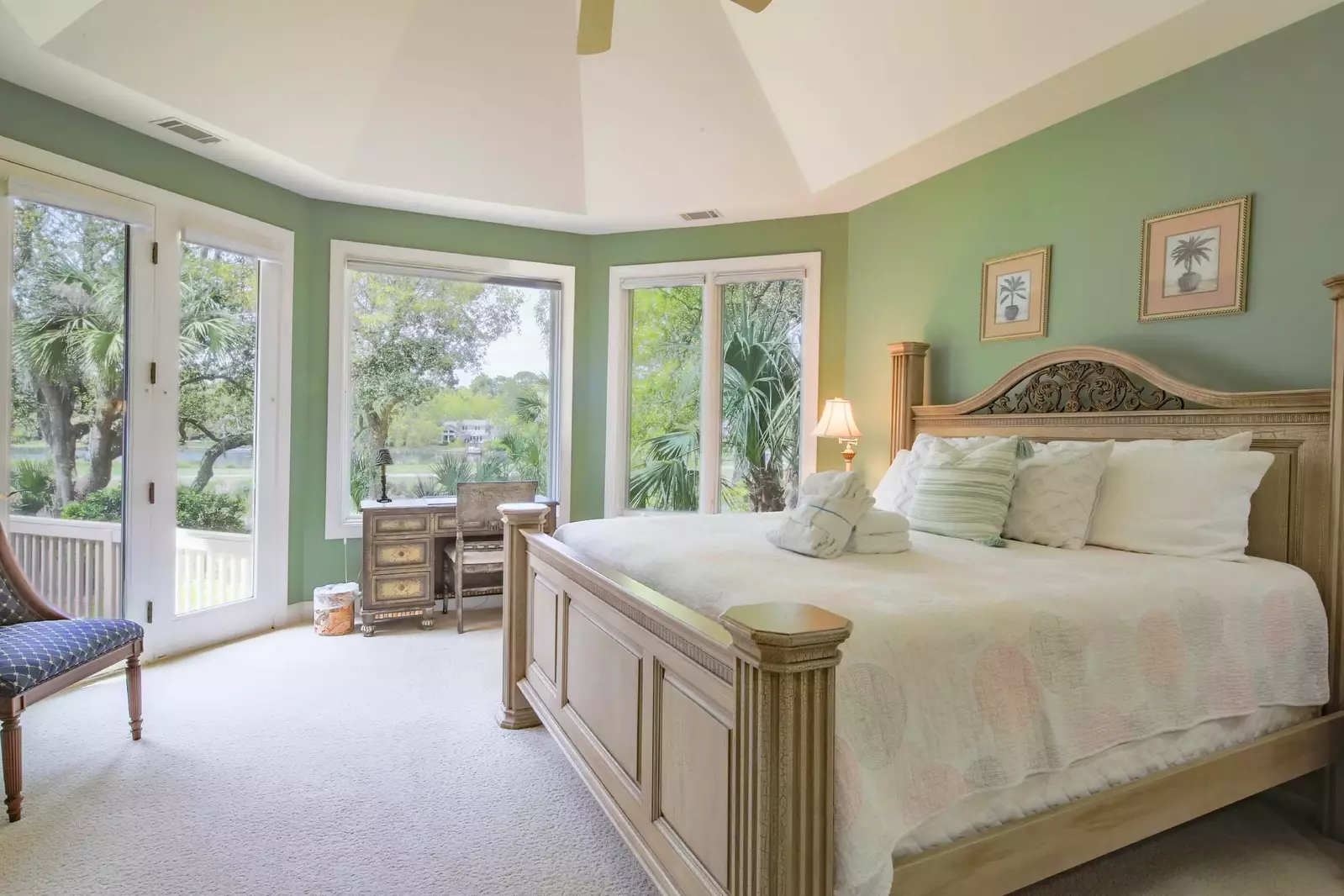 The master suite enjoys lovely natural light, golf course views and access to the back deck.
