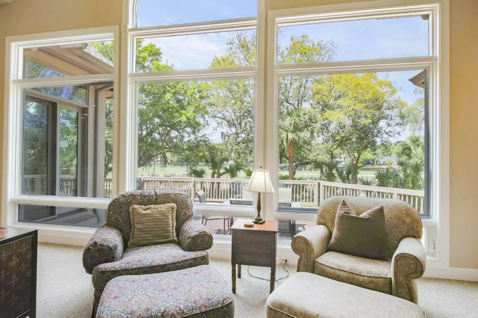 The living room also looks out onto the back deck, golf course and lagoon.