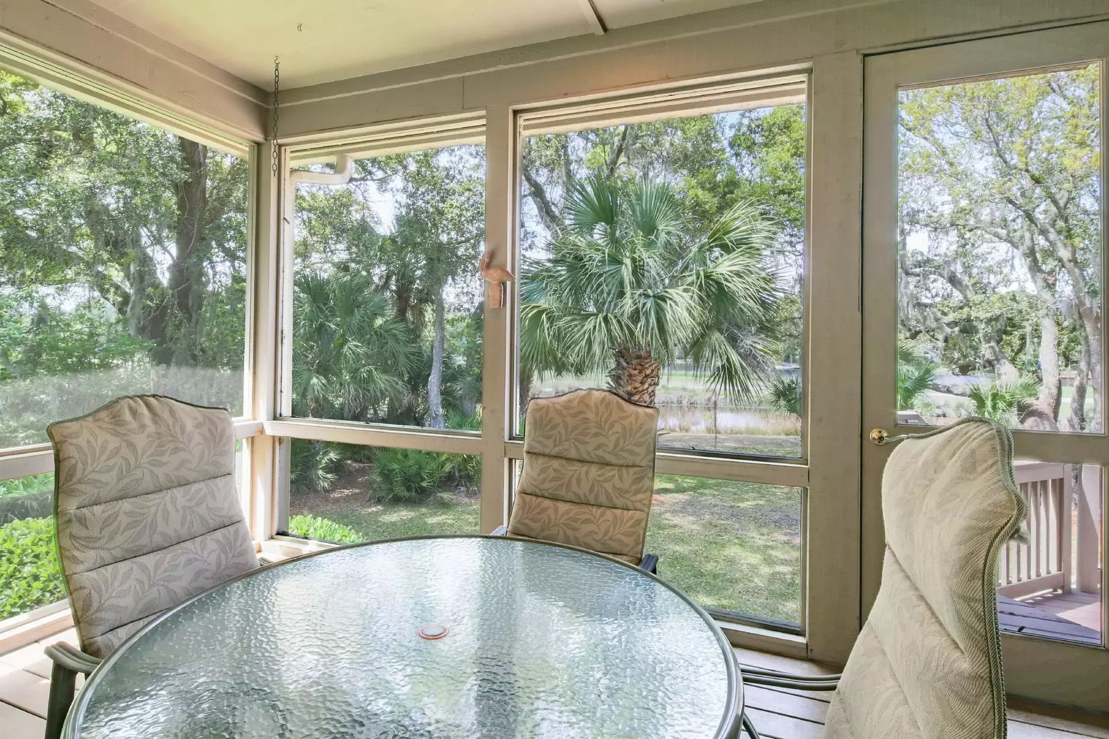 This screened porch is accessible from the back deck and the dining area.