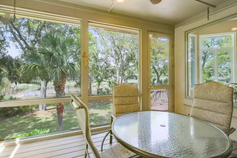 The screened porch features great views of the backyard and lagoon.