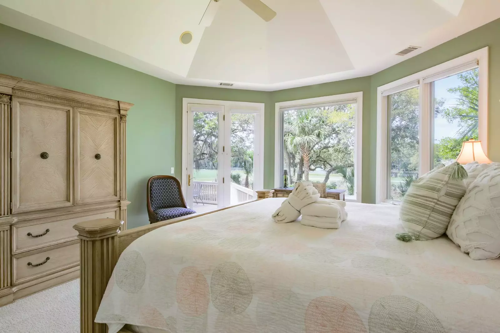 The master suite also has golf course views, access to the back deck, vaulted ceilings and a ceiling fan.