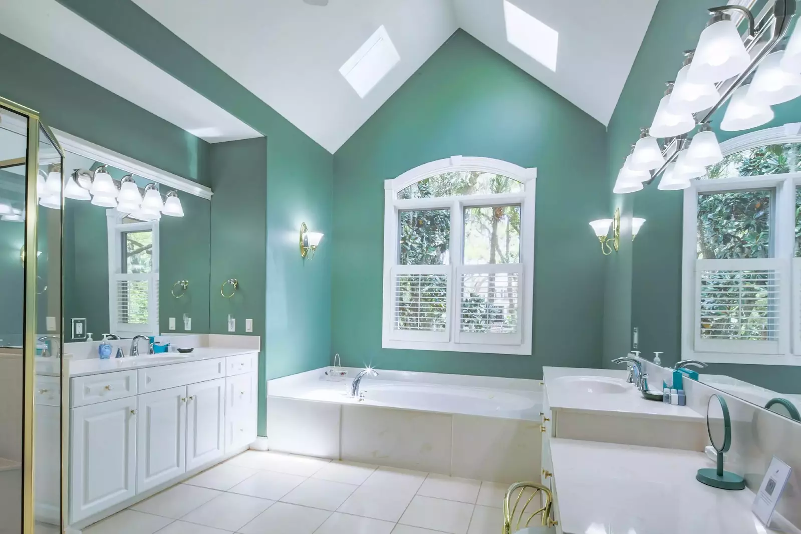 The en suite bathroom has two vanities and a soaking tub.