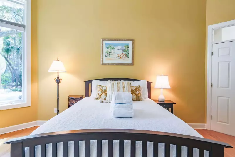 The front suite features a queen bed, night stands and reading lamps.