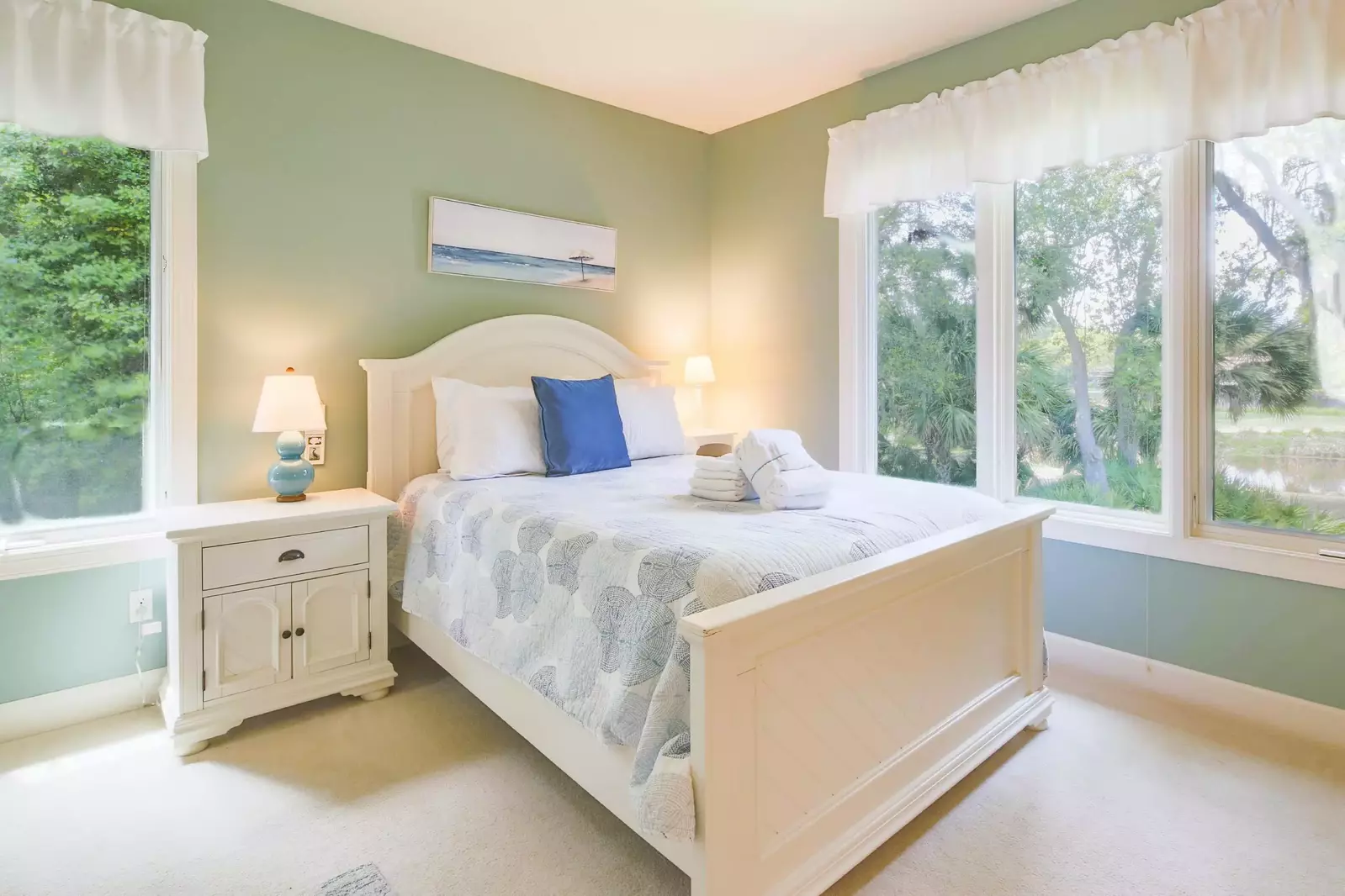 The queen suite features a queen bed, night stands and reading lamps.