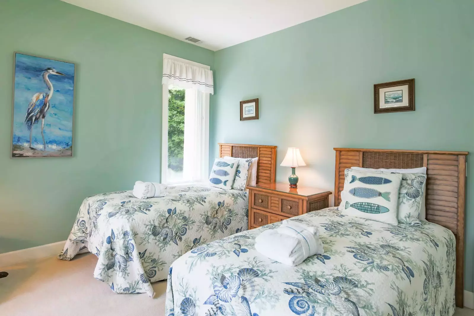The twin suite features two twin beds and a night stand with a reading lamp.