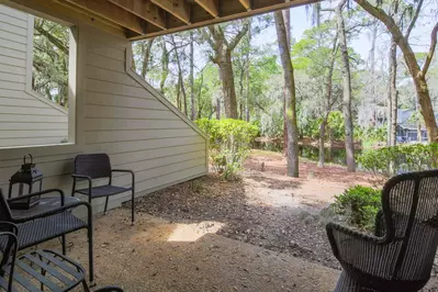 The covered balcony features wooded lagoon views.