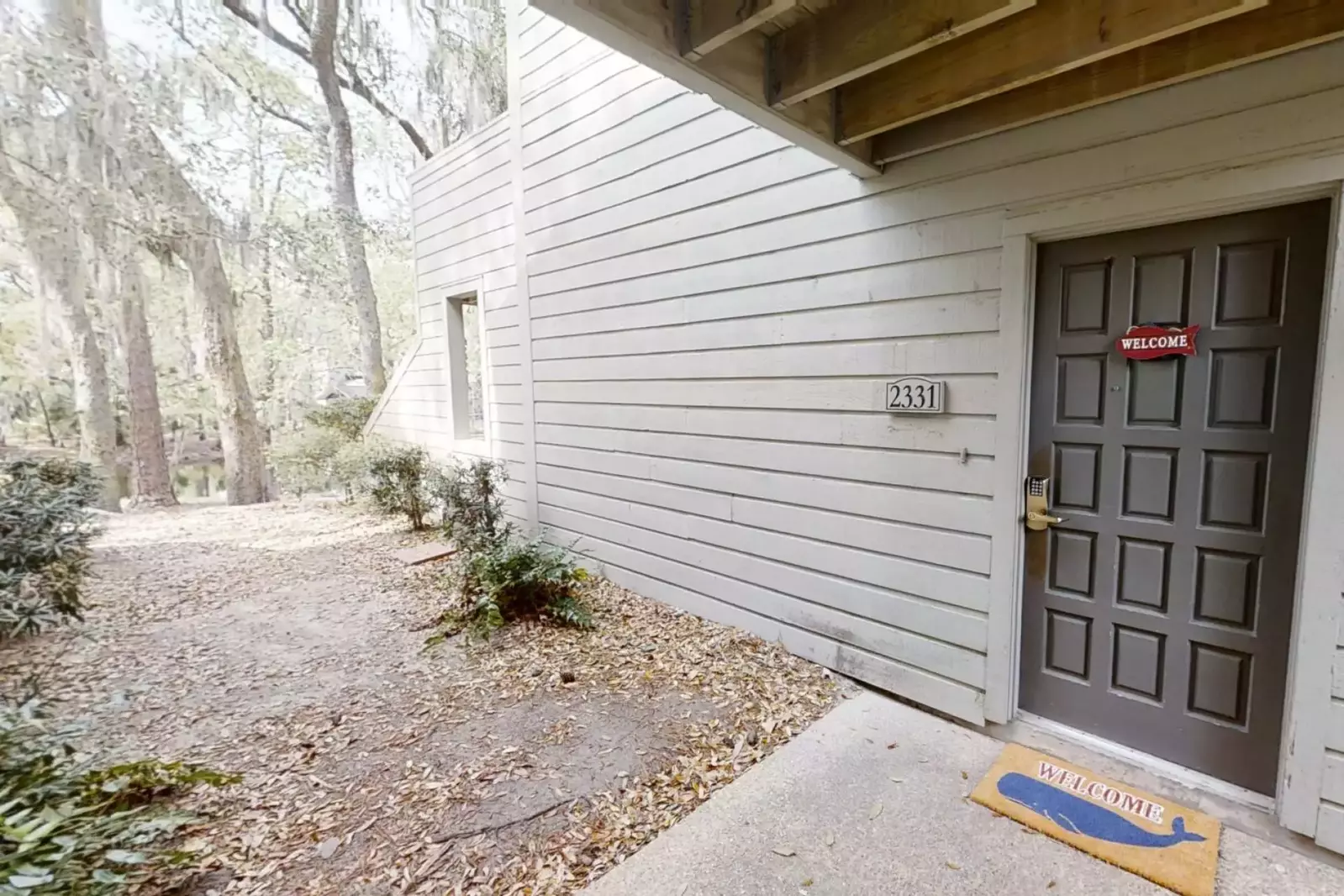 2331 Racquet Club is surrounded by gorgeous Lowcountry trees and a lagoon behind the villa.