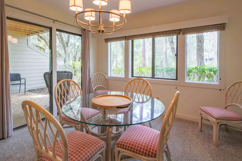 The dining room features sliding door access to the patio as well as beautiful wooded lagoon views.