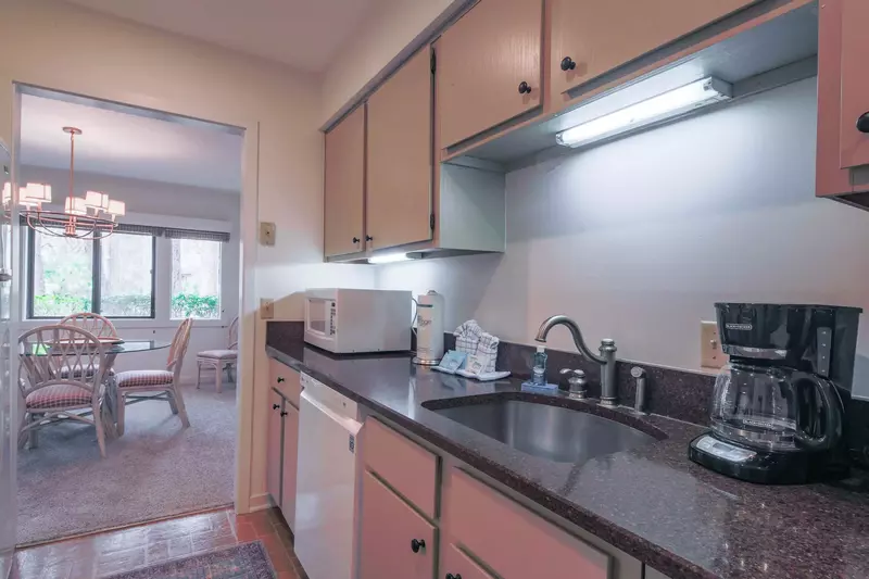 The kitchen features a dishwasher, microwave, coffee maker and granite counters.